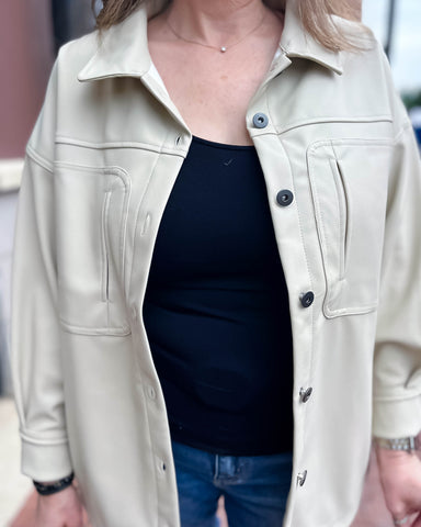 close-up of ecru faux leather jacket