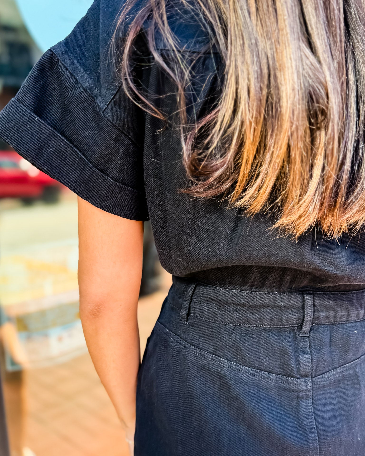 Person wearing a black outfit with blurred background