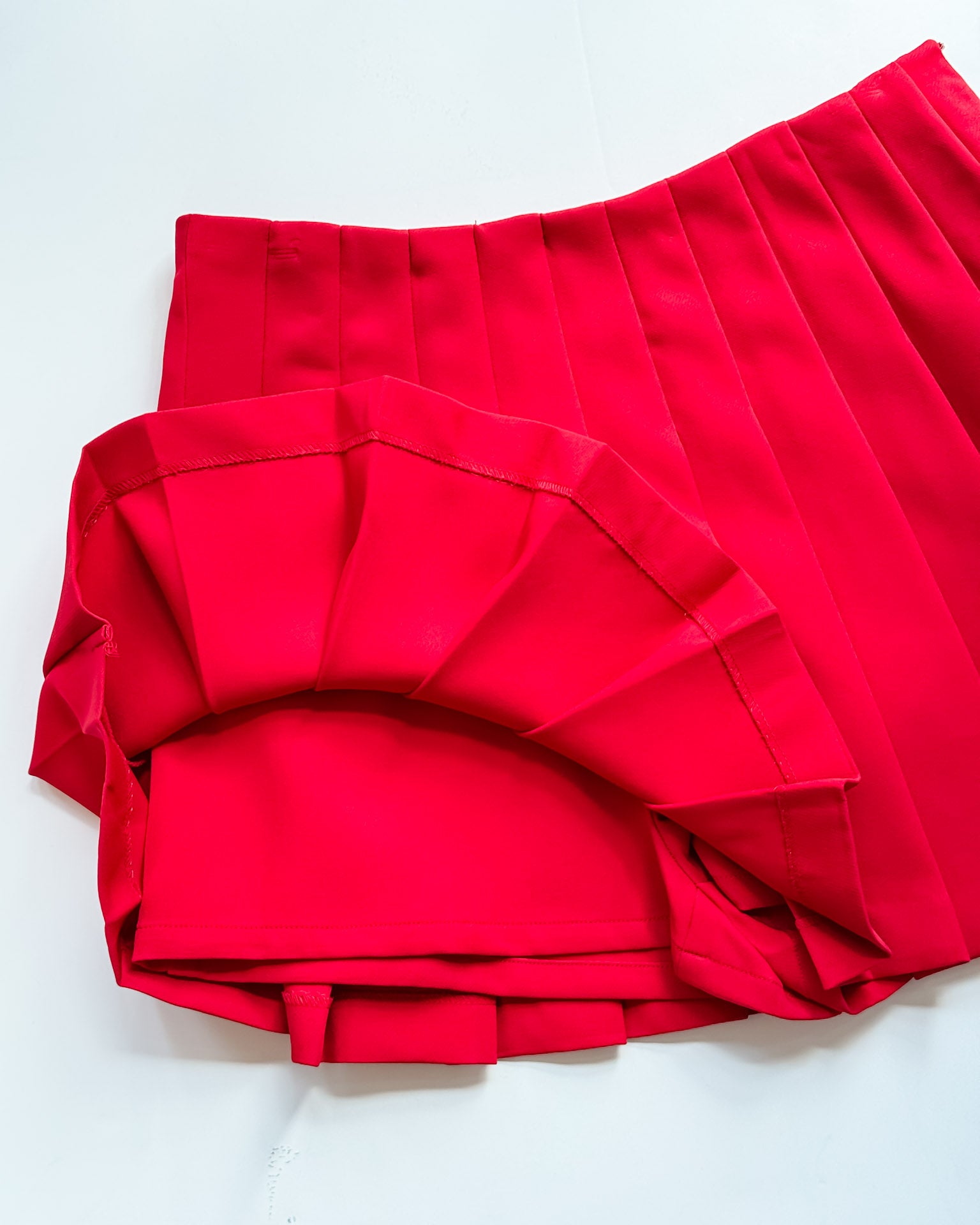 Red skirt with ruffled details on a white background