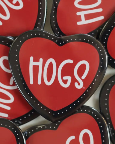 Red heart-shaped buttons with 'HOGS' text on a white background