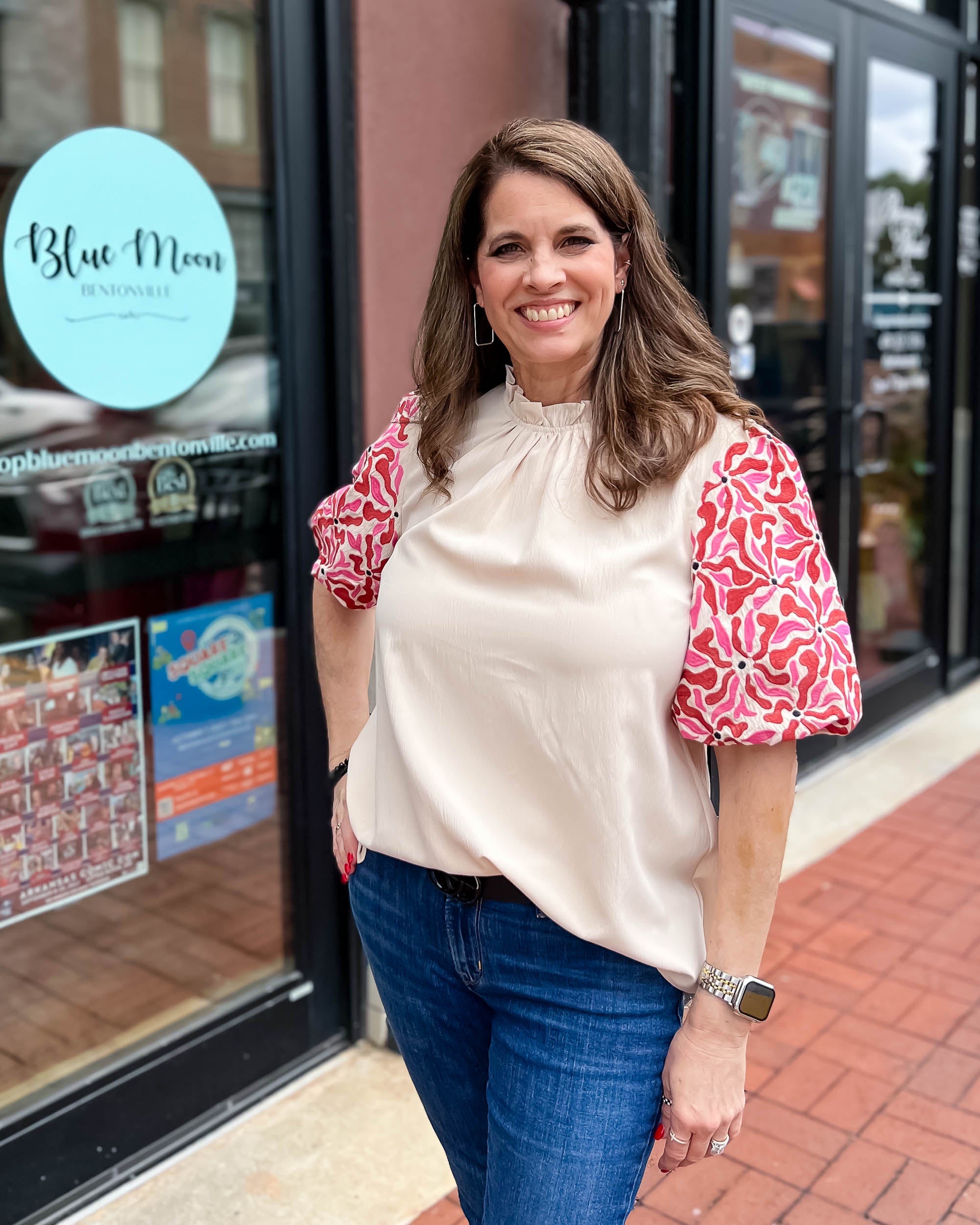 woman wearing mockneck top with puff sleeves