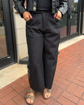 Black faux leather pants with contrast denim panels