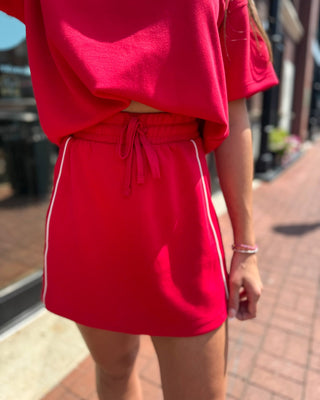 Red modal varsity skort by Rae Mode, shown front, back, and detail views on model