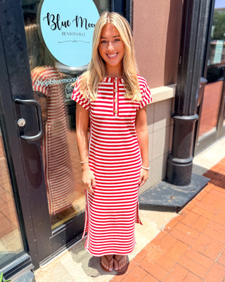 Model wearing a red and white striped Henley midi dress with rolled sleeves and button-front neckline.
