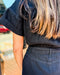 Person wearing a black outfit with blurred background