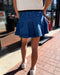 Person wearing a blue skirt on a sidewalk