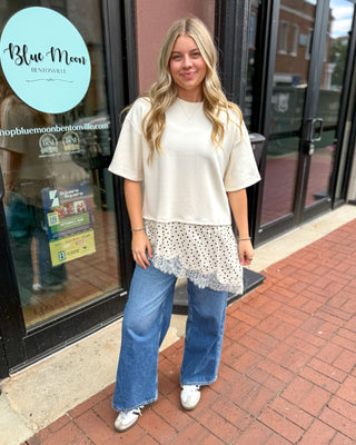 Ecru knit top with polka dot lace contrast hem