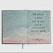 Open book with ocean scene and inspirational quote on a white background