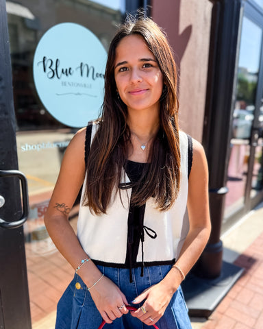 Woman standing in front of a store with 'Blue Moon' sign