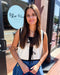 Woman standing in front of a store with 'Blue Moon' sign