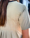 Person wearing a light-colored shirt with a blurred background