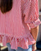 Red and white striped shirt with ruffled hem worn by a person.