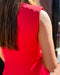 Person wearing a red dress with a blurred background