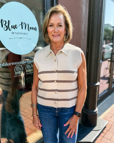 Woman standing outside a building with 'Blue Moon Bentonville' sign in the background