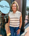 Woman standing outside a building with 'Blue Moon Bentonville' sign in the background