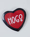 Heart-shaped button badge with 'HOGS' text on a white background