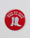 Red button badge  with white cowboy boots and 'Wooo Pig Sooie!' text on a white background