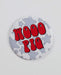 Button badge with 'WOOO PIG' text on a star-patterned background