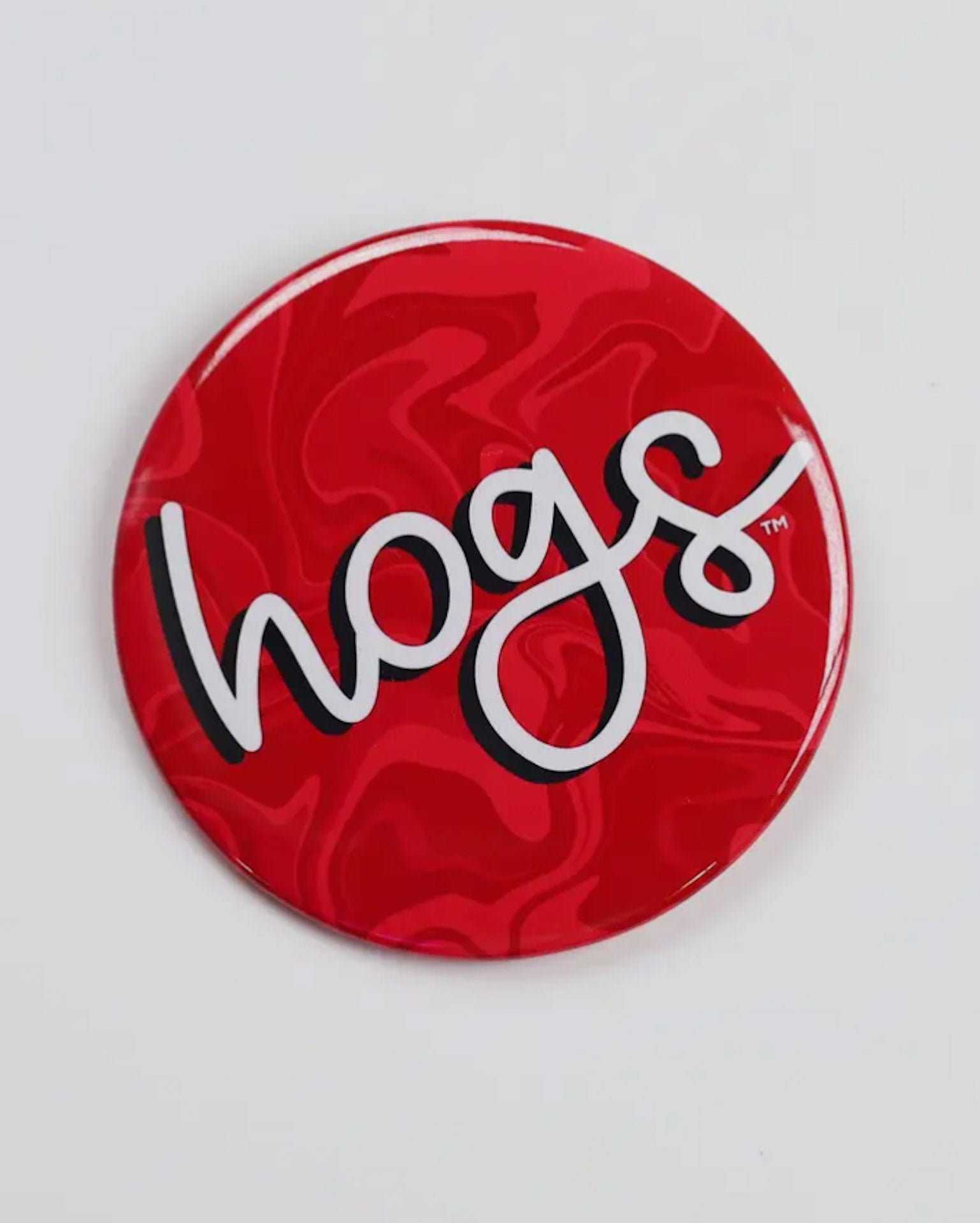 Red button badge with 'hogs' logo on a white background