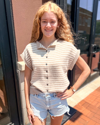 Model wearing a taupe and ivory striped short sleeve sweater cardigan with a collared neckline, button front, and light wash denim shorts.