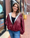 woman wearing wine faux leather hoodie jacket
