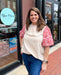 woman wearing mockneck top with puff sleeves